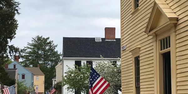 American flags on houses in a residential neighborhood.