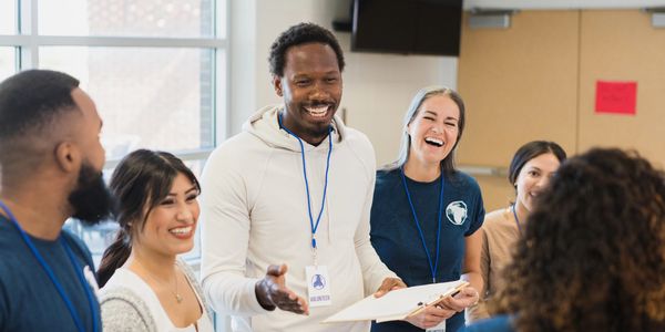 Group of diverse colleagues happily discussing in a bright office space.