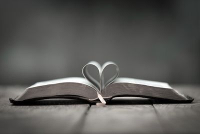 Bible pages folded into a heart represents clients wanting their Christian faith included in therapy