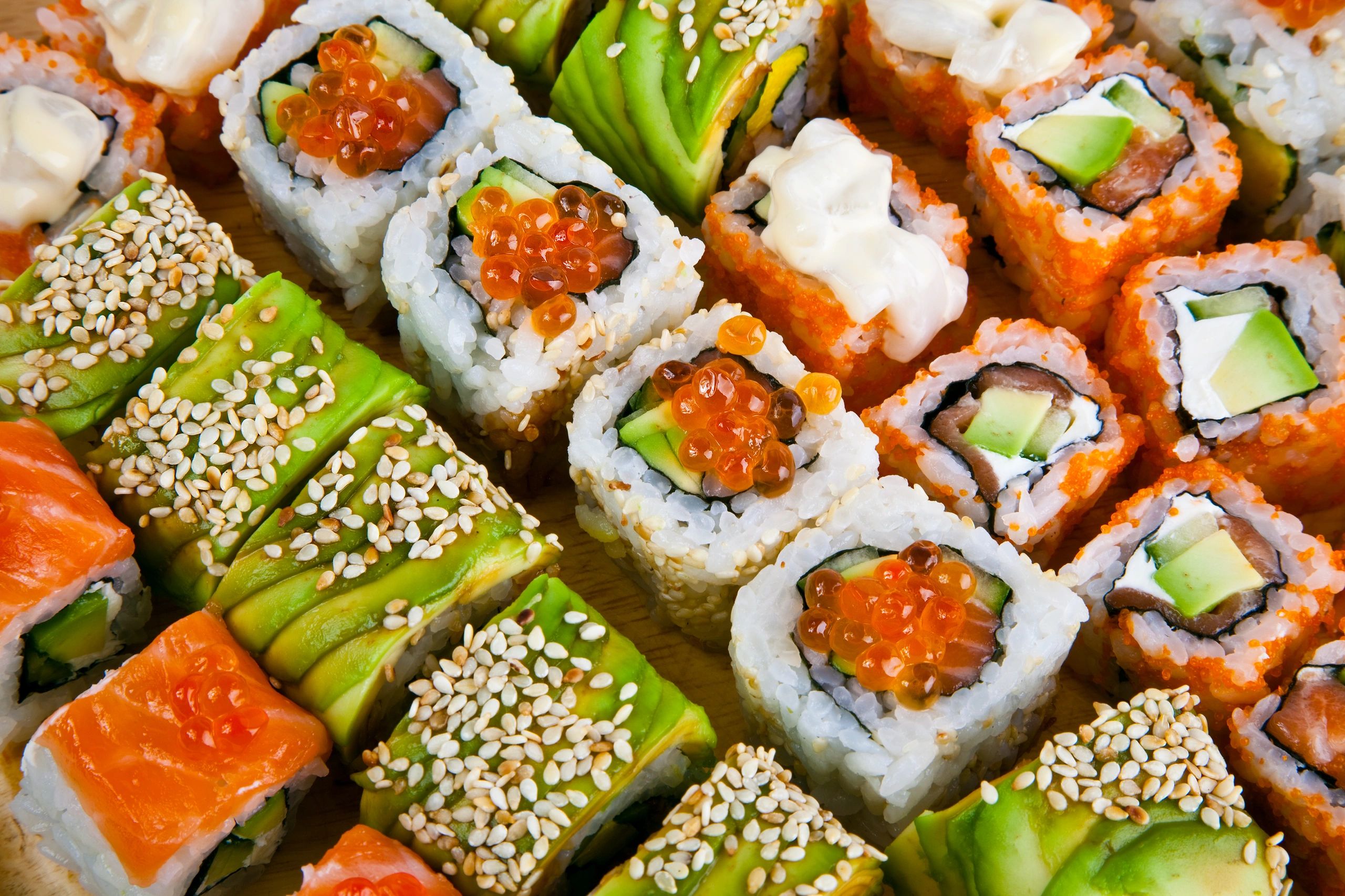 Variety of colorful sushi rolls.