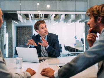 Businessman explaining ideas during a meeting in a modern office.