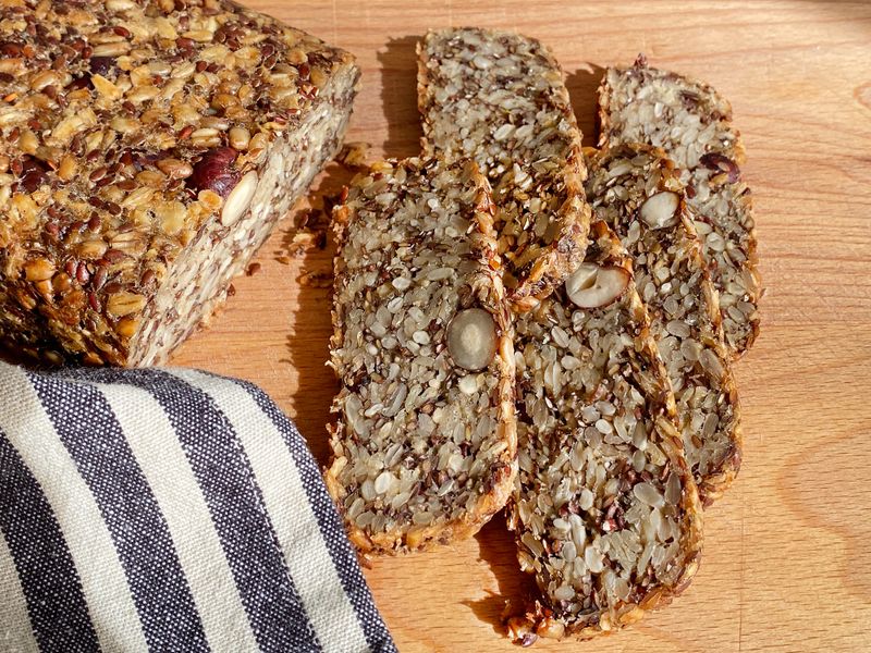 Homemade glutenfree bread with hazelnut and flax seeds on a wooden Board background close-up. Food for diet and health. Healthy almond bread, Keto, ketogenic diet, paleo, low carb fat.