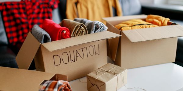 Boxes of clothes labeled for donation, ready to be given away.