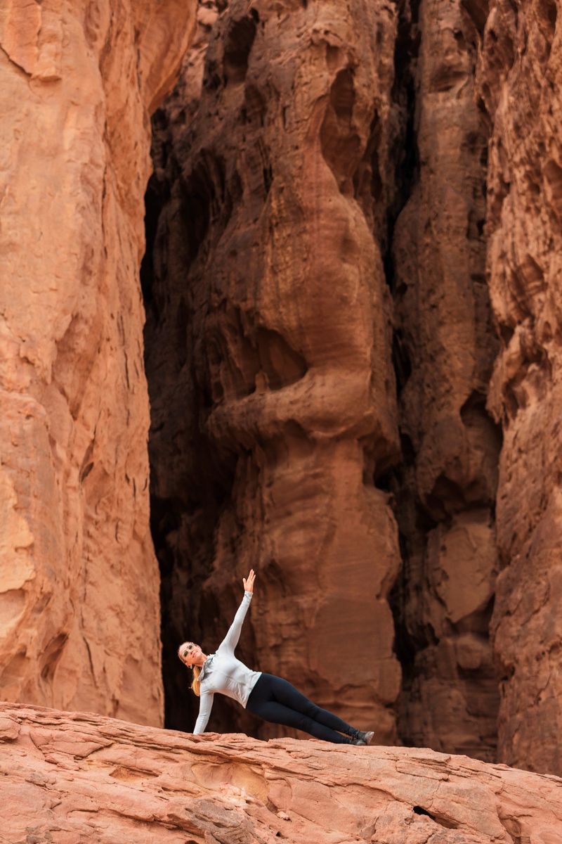 Woman exersising in wild red deserted rocky area