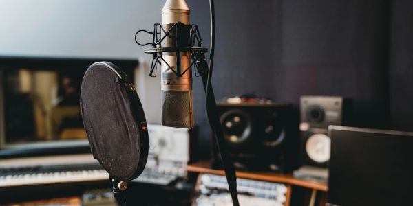 Professional video camera setup with microphone and monitor.