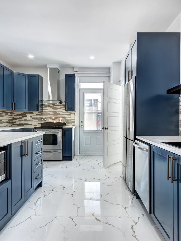 "Elegant kitchen remodel with updated cabinets, backsplash, and professionally installed plumbing for sink and appliances."