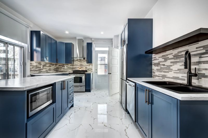Empty beautiful old style modern renovated apartment in 2 floors Canadian house with nice equipped contemporary kitchen with appliances, stove, fridge, washer and dryer, new bathroom and powder room, new wood floors and old staircase
