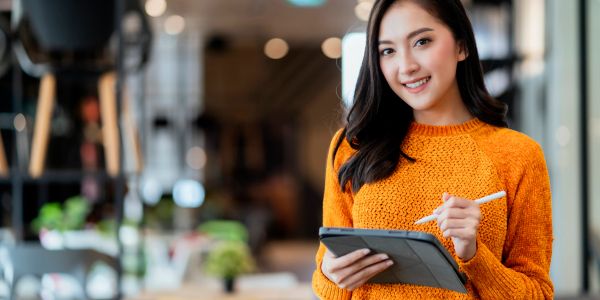 Young woman using a digital tablet indoors.