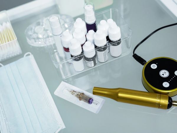 Cosmetic tattooing equipment on a table.