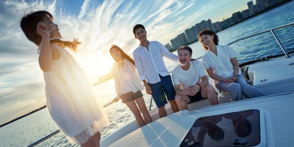 Family enjoying a boat ride at sunset.