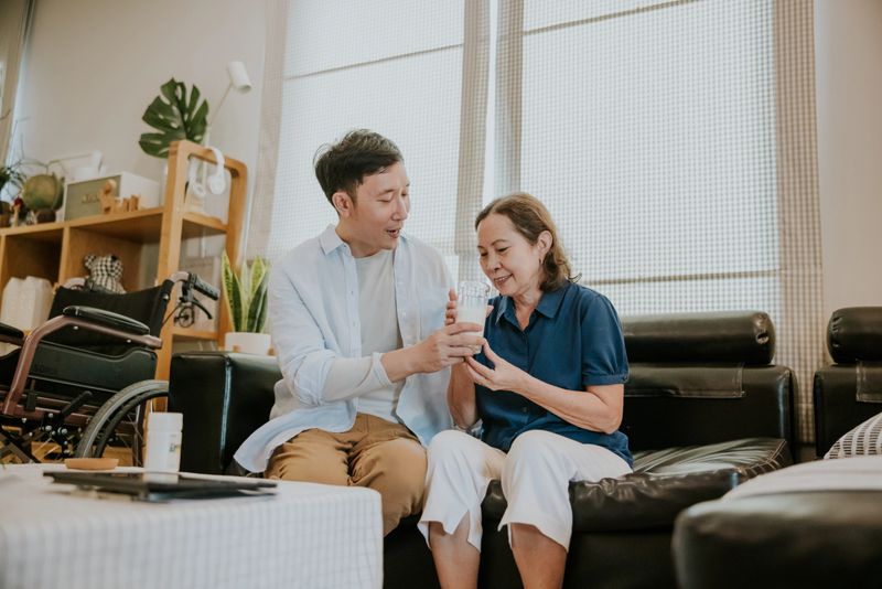 Asian mother is happy by the milk she received from her son.