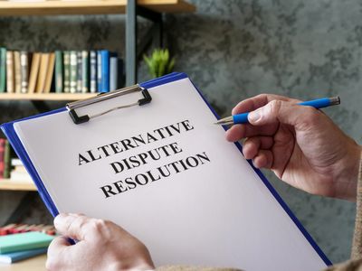 Person holding a clipboard with 'Alternative Dispute Resolution' document.