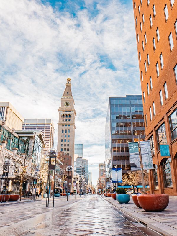 Downtown Denver street with clocktower, a major hub for conventions and business events.