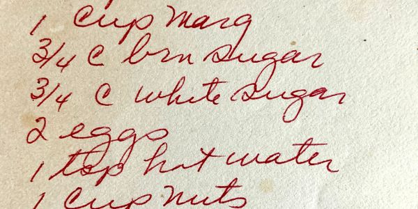 Handwritten recipe ingredients list in red ink on aged paper.
