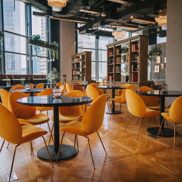 Modern cafe with yellow chairs and natural light.