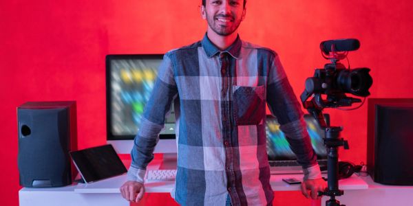 Man smiling in a modern recording studio.