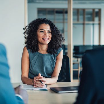 Smiling woman in a business meeting.