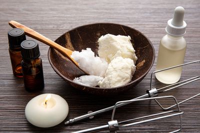 Ingredients and tools for homemade skincare cream.