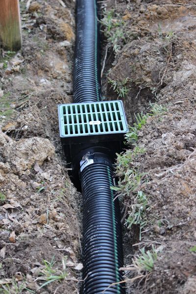 Landscape drainage supplies including pipe, fittings, and channel drains at Simmons Landscaping & Su