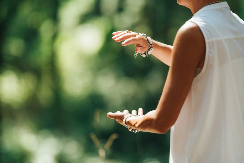 Tai Chi in Nature. Mature woman exercising Tai Chi in nature, Close up on hands