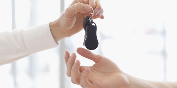 Handing over a set of keys to another person.