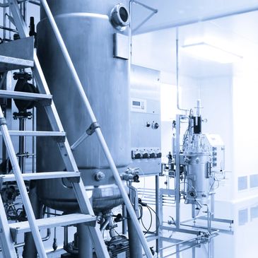 Industrial stainless steel tanks and equipment in a sterile processing room.