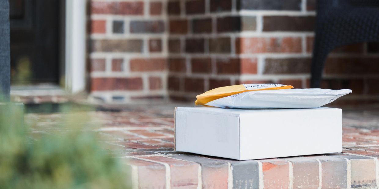 Packages left on a brick porch step.