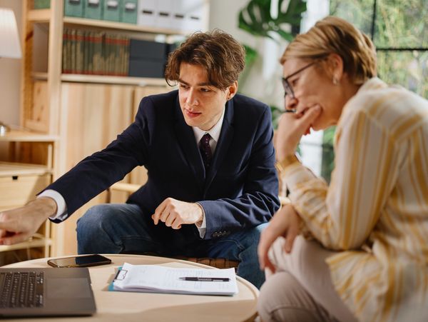 Two colleagues discussing work intently in a cozy office setting.