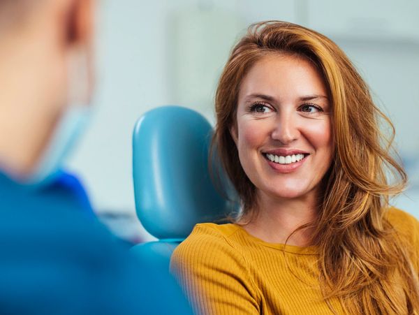 Woman smiling in a dentist's chair.