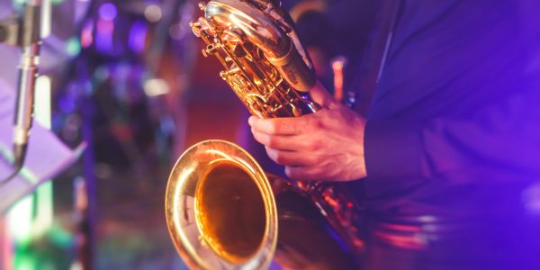 Close-up of a person playing a saxophone.