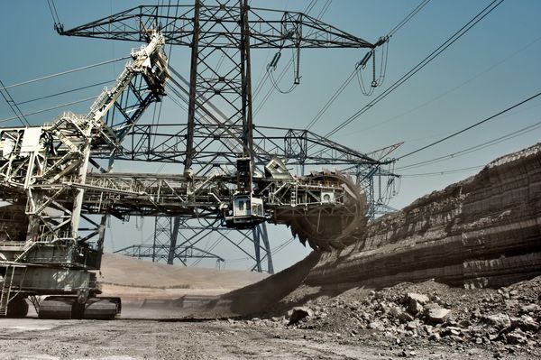 A mining machine mining under electrical power lines. Nam cables supplies to the mining industry.