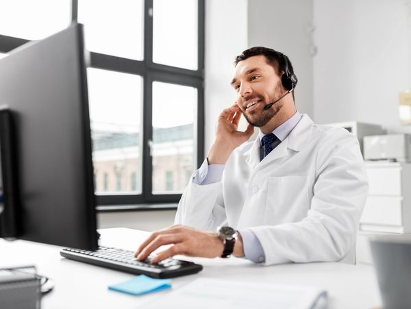 Doctor typing a report on laptop