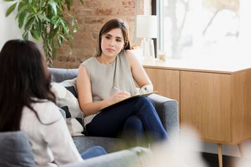 Therapist attentively listening to a patient.