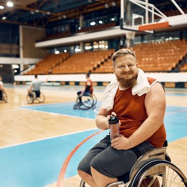 Man in wheelchair on basketball court.