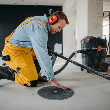 Restoration technician performing sewage and contaminated water cleanup with professional extraction
