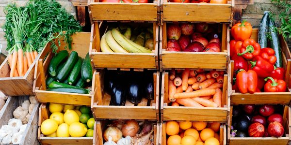 Fresh fruits and vegetables neatly arranged in wooden crates.