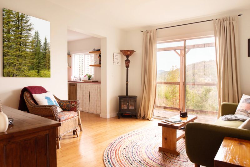 Comfortable and cozy living room with patio doors leading out to a deck with a scenic view