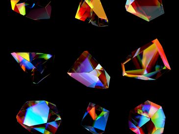 Nine colorful, multifaceted crystals on a white background.