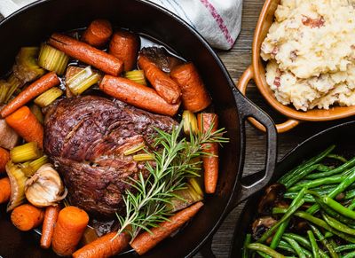 Pot roast with carrots, garlic, celery, and rosemary.