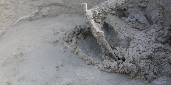 Wet cement being troweled smooth.