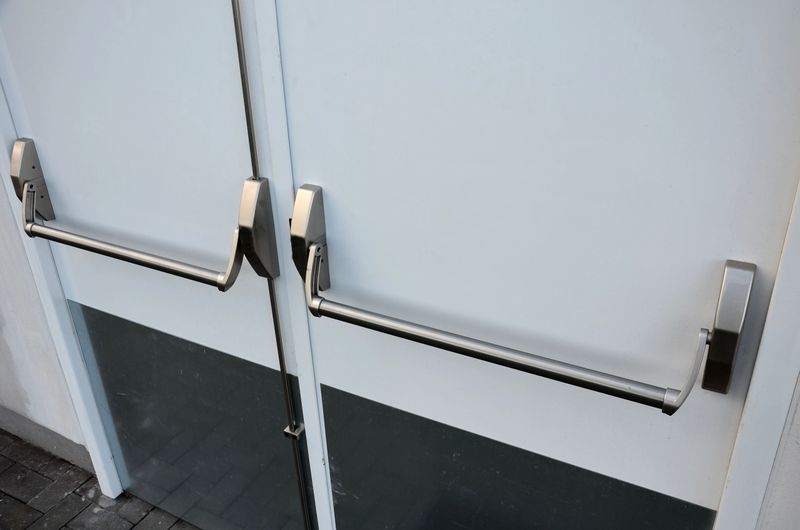 rear door of department store or warehouse with handle for quick release of door. evacuation door handle, panic fire button. in dangerous crush, all you have to do is lean horizontal pushing, push,