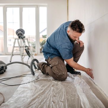 Man preparing wall for renovation.