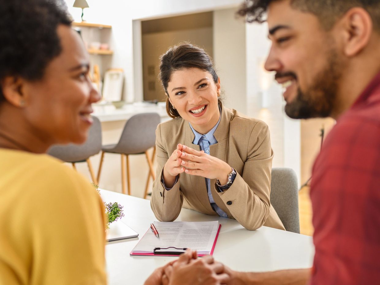 A couple discussing with a professional advisor at a table.