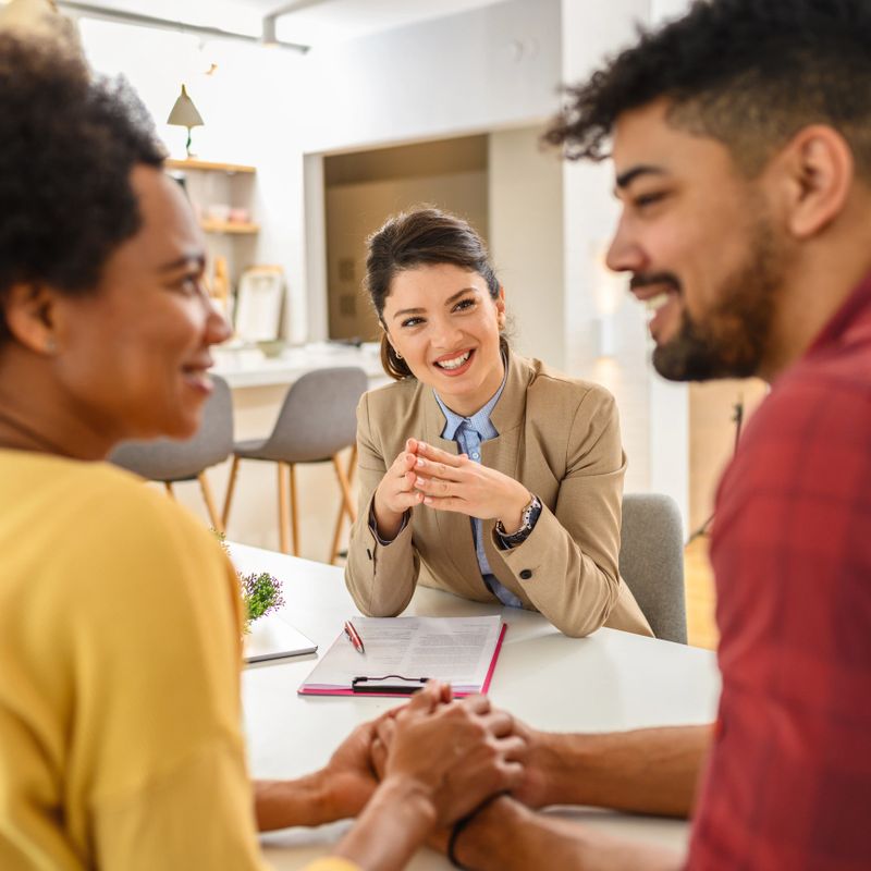 The black couple is in a meeting with their financial advisor.