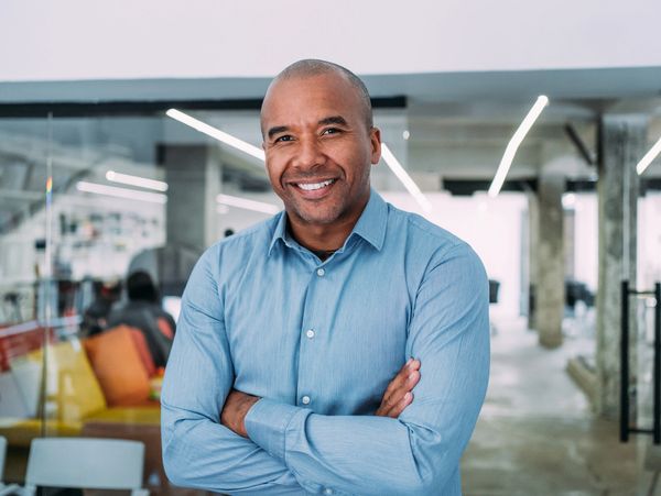 Confident man smiling in an office.