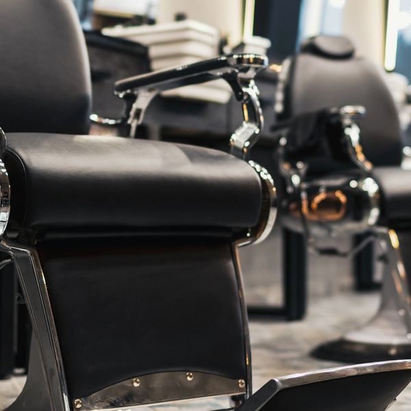 Close-up of a black barber chair in a barbershop.