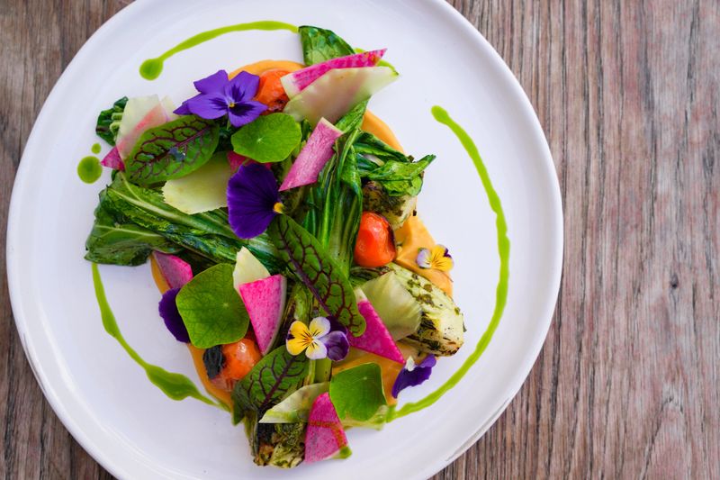 farm to table salad mixing beautiful presentation with fresh ingredients and vibrant colors.