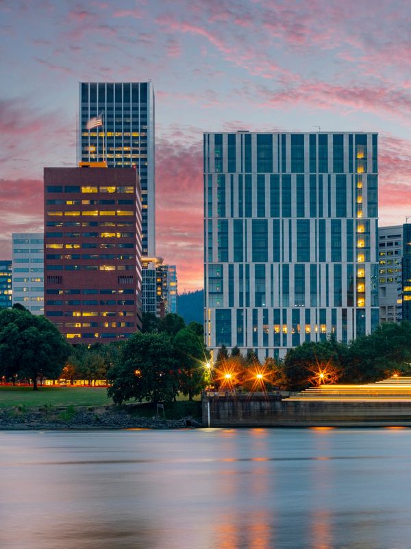Portland riverfront buildings at dusk near major convention venues.