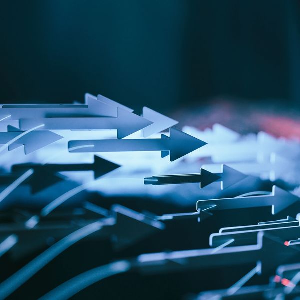 Multiple arrows pointing right in a blue-toned abstract image.