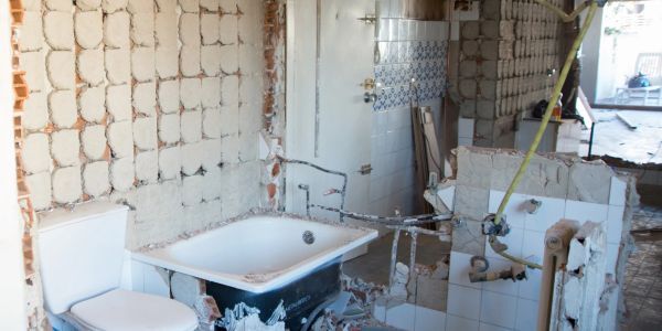 Bathroom under renovation with exposed walls and fixtures.